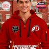 Man modeling Utah Utes red champions hoodie at university building.
