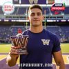 A Washington Huskies player holding a whiskey bottle with a red cap and the team's logo in front of the stadium.