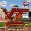 VT logo shaped whiskey bottle displayed on a wooden table near a football field!