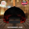 Back view of a black baseball cap with a red and orange flame design around the bottom edge.!
