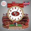 A wall clock shaped like a football stadium, San Francisco 49ers themed, with a gold rim and the team's logo on the clock face.!