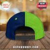 Back view of a two-tone baseball cap with blue and green panels and an adjustable strap.!