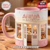 Pink bakery mug! Reads ANIVIA BAKERY, has shop design with cakes! White, tan, bread, and pink colors!