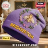 Purple beanie with 'Bridgerton' in gold, bee & floral wreath design! Get your royalcore look!