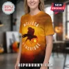 Yellow tee with raven graphic. Text: MELISSA ETHERIDGE. Sunset vibe!