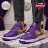 Purple sneakers with gold swoosh and Omega Psi Phi letters. Greek frat-themed footwear!