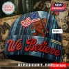 Blue beanie with Bigfoot holding a flag, 'We Believe' text in red. Custom name tag!