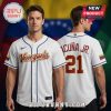 White baseball jersey with blue trim, gold 'Venezuela' script, and 'ACUÑA JR. 21' on back!