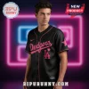 Black baseball jersey with pink script Dodgers text, LA logo, and pink star on sleeve!