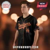 Black baseball jersey with orange 'Dodgers' script text, LA logo, and orange piping on the sleeves and front placket!