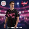 A black baseball jersey with pink trim, featuring the word Dodgers in pink script font and the number 00 below it!