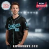Black baseball jersey with light blue piping and script 'Dodgers' text, number '00', and 'LA' logo on the sleeve!