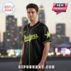 Black Dodgers baseball jersey with neon yellow script text, piping, and a large star on the sleeve!