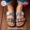 Grey and blue sandals with 3D space charms featuring NASA and Artemis logos, a rocket, astronaut, moon, and satellite!
