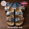 Grey and blue NASA Artemis II sandals with 3D charms of a rocket, astronaut, moon, and planet on cork-style soles!