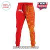 Red split-leg joggers with a white dolphin graphic and a yellow and red Aboriginal art style dot and line pattern!