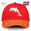 Red baseball cap with a white dolphin graphic and an orange and yellow Aboriginal art style dot pattern on the brim!