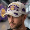 Distressed gray cap with purple and yellow Lakers logo! Gold embroidered 80th ANNIVERSARY 1946-2026 text!