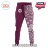 Maroon joggers with a split design featuring a white Sea Eagles logo and an Indigenous Australian dot art pattern in white!