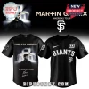 Black Martin Garrix x Giants baseball jersey with Americas Tour graphic, SF logo, and +x logo in white text!