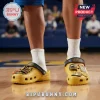 Yellow Crocs-style clogs with black straps, gold Michigan Wolverines charms, and MICHIGAN Wolverines text!