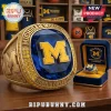 Bold gold Michigan Wolverines championship ring with blue gem, gold M logo, and 'men's basketball' text!