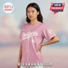 A pink button-up baseball jersey with the text 