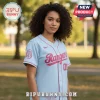 A light blue and pink women's baseball jersey with the word Rangers in a script font across the chest!