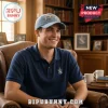 Man in navy Phi Delta Theta crest polo and blue distressed hat with patch reading PHI DELTA THETA EST. 1848!
