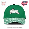A green baseball cap with a white running rabbit logo and a green and white Indigenous Australian dot art pattern on the brim!