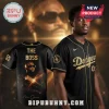 A black and gold Dodgers baseball jersey with 'THE BOSS' and a graphic of rapper Rick Ross on the back.!