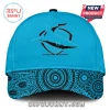 Cyan blue baseball cap with a black stylized shark logo and an Aboriginal dot art pattern with concentric circles on the brim!