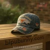 Distressed denim baseball cap with orange longhorn on Texas patch. Features '233RD ANNIVERSARY 1893-2026' embroidery!