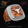 Silver and orange championship ring with a faceted amber stone, silver longhorn logo, and 