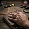 Silver collegiate ring with large orange stone, white longhorn bull head graphic, and 'TEXAS LONGHORNS' text on a brown book!