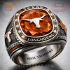 Silver and bronze Longhorns championship ring with large orange gem, white and orange stones,