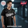 Black baseball jersey with white piping and 'Dodgers' script text across the chest with 'LA' logos on the front and sleeve!