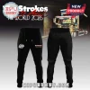 Black sweatpants with The Strokes band logo in white and red text reading The Strokes The World 2026 tour merch!