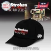 Black baseball cap with white and red text The Strokes Loves Awaits The World 2026 on the front and a side logo!