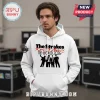 White hoodie with The Strokes band graphic! Text says Reality Waits The World 2026 in black and red lettering!