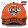 Orange cap with a stylized roaring tiger head logo in black and white and an Indigenous dot art pattern on the brim!