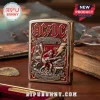 Gold and red AC/DC 53rd Anniversary 1973-2026 Zippo-style lighter with engraved Angus Young, Hells Bells, Back in Black, Let There Be Rock text!