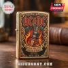 Gold lighter with AC DC logo, flaming guitar, and High Voltage Rock N Roll text featuring red and blue jewel accents!