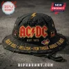 Black distressed AC/DC bucket hat with red/gold logo, yellow lightning bolt, and patches! Text: ROCK N' ROLL HELLISH FOR THOSE ABOUT TO ROCK EST. 1973!