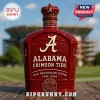 Red ceramic bottle decanter with Alabama Crimson Tide logo, crown topper, and 134th Anniversary text on a wooden surface!