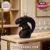 Black ceramic decanter shaped like a Xenomorph alien head on a modern wooden bar counter with two wine glasses!