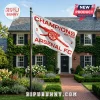 White Arsenal FC flag with red cannon graphic and Champions 25/26 text flying on a pole in front of a brick house!