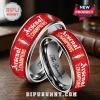 Red metal Arsenal Champions 25 26 ring set with white text and trophy icon on wooden background!