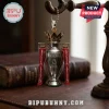 Silver Arsenal Premier League trophy keychain with a gold crown and red ribbons on a blurred wooden background!