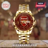 Gold Arsenal FC analog watch with red dial, crest logo, and Premier League Champions text on a wooden surface!